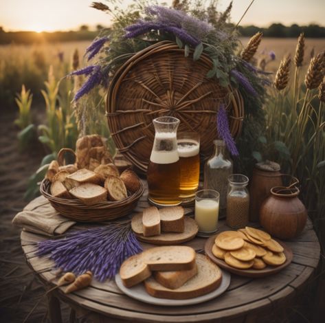 A feast of bread, mead, and lavender sprigs on a table in front of a woven wheel standing in a wheat field. Lammas Lughnasadh Aesthetic, Lughnasadh Aesthetic, Lughnasadh Ritual, Lughnasadh Altar, Lammas Altar, Lammas Lughnasadh, Pagan Calendar, Beltane, Harvest Festival