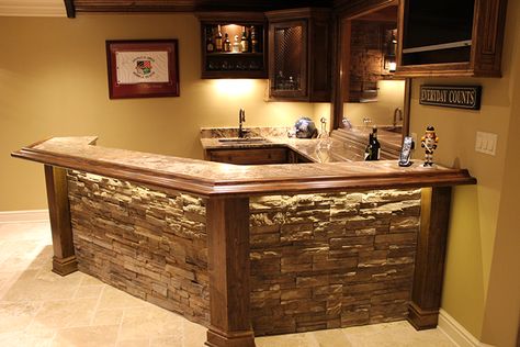 The natural wood molding beautifully compliments the intricately textured granite countertops. Home Bar Plans, Basement Bar Plans, Bar Plans, Basement Bar Designs, Diy Home Bar, Stone Bar, Small Basements, Man Cave Home Bar, Basement Makeover