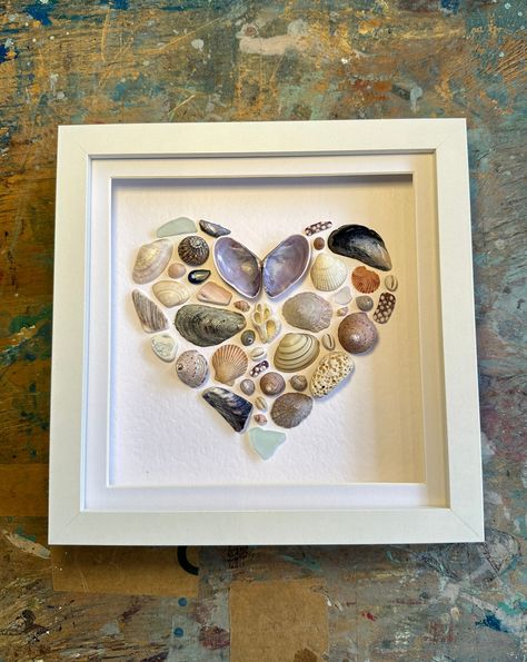 This purple/blue toned heart shell piece is made from materials carefully collected exclusively from the North Coast of Ireland. This highly detailed piece includes; mussels, sea urchin, scallop, cowrie, flat topshells, seaglass, periwinkles and many more! The beautiful colours in this piece showcase the variety of she Shell And Stone Art, Mussels Shell Crafts, Whale Tail Sea Glass Art, Shell Collage Art, Beach Shell Art, Framed Shell Art, Sea Urchin Shell Crafts, Muscle Shell Art, How To Display Shells