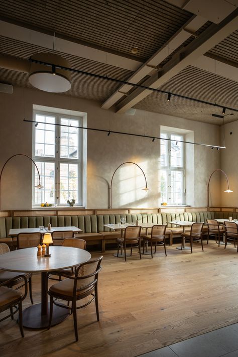 Brasserie Post is located in the old high-ceilinged post office  in Copenhagen. Troldtekt line allows the ceiling to follow the direction of the floor planks, discreetly uniting the entire room through the uniform lines and soft beige colour. Click the picture to see more.   #goodacoustics #holzwolleplatten #träullsplattor #woodwoolpanels #troldtekt | Architects: Zeso Architects, BRIQ French Brasserie Interior, Brasserie Interior, Acoustics Design, French Brasserie, Modern French Country, Outdoor Baths, Bar Interior Design, Cafe Table, Ceiling Installation