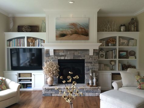 Gas fireplace with stacked stone, pieced hearth, corbels, board and batten detail above the mantle, and built-ins on both sides Farmhouse Fireplace Ideas, Rustic Farmhouse Fireplace, Design Camino, Farmhouse Fireplace Decor, Hearth Stone, Fireplace Bookshelves, Fireplace Shelves, Fireplace Built Ins, Family Room Fireplace