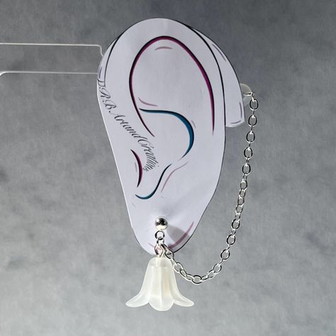 This elegant chain with a frosted flower charm and silver plated chain and studs is the perfect addition to any outfit! #fashion #hearingaids #hearing #hearinghealth #charms #cutecharms #floral #flowerearrings #daintyjewelry #studsearring #bridaljewellery #bridesmaidgift #bridesmaid #brideaccessories #elegantjewelry Frosted Flower, Cochlear Implant, Teacher Material, Chain Earring, Bride Accessories, Earring Studs, Drop Beads, Hearing Aids, Cute Charms