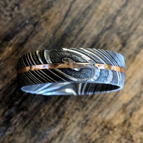 This is a USA made comfort fit 7mm wide Damascus Steel with a rounded top profile, acid etch, and 1 millimeter center 14k Rose Gold inlay is simply stunning. It is very comfortable to wear with a rounded comfort fit design. This ring is hand finished & designed by jewelry artisans who have a passion Damascus Steel Wedding Band, Damascus Steel Ring, Special Ring, Jewelry Companies, Mens Wedding Rings, Men's Rings, Damascus Steel, Steel Ring, Damascus