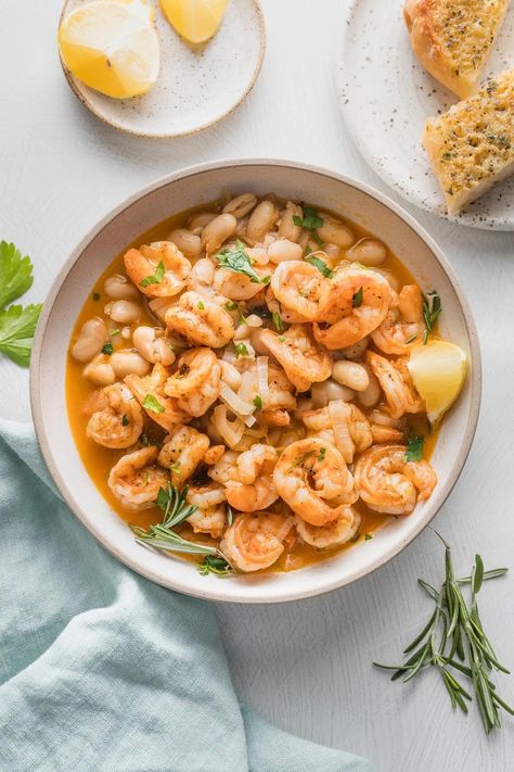 This lemony Shrimp and Bean Stew is a dream for cold days and busy nights. It's hearty, flavorful, and cozy, with tender shrimp and Cannellini beans simmered in a rich lemon and rosemary-infused broth. Best of all, it's easy to make in just about 25 minutes. Shrimp And Beans, Cannellini Bean, Lemon Shrimp, Pan Seared Scallops, Chickpea Stew, Salad Sauce, Bean Stew, Recipes Appetizers And Snacks, White Bean Soup