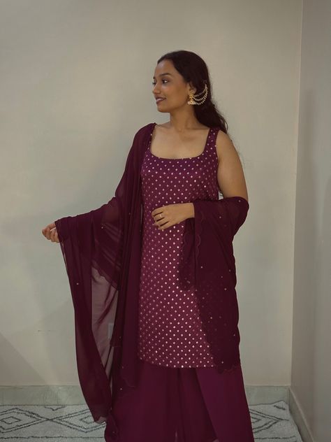 This suit set features a sleeveless short embroidered kurti with a square neckline. Paired with wide-leg palazzo pants & scalloped dupatta with zari motifs all over. Wine Suit, Scalloped Dupatta, Embroidered Kurti, Wide Leg Palazzo Pants, Suit Set, Square Necklines, Fabric Details, Palazzo Pants, Indian Outfits