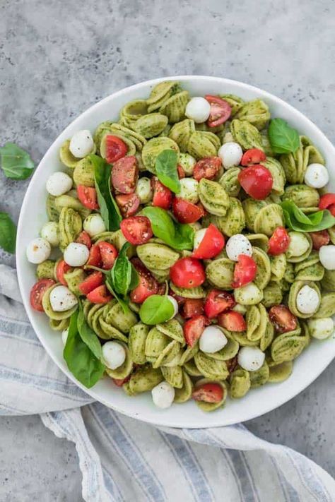 Caprese Pasta Salad. The ultimate summer potluck dish, it's made with chunks of pearl mozzarella, juicy grape tomatoes and tossed in a bright pesto sauce! | Pasta Salad | Pesto Recipes | Caprese Salad | #pasta #salad #pesto #potluck #feelgoodfoodie Potluck Sides, Pasta Salad With Pesto, Summer Potluck Dishes, Pesto Food, Pesto Recipes, Resep Pasta, Caprese Pasta Salad, Summer Potluck, Sommer Mad