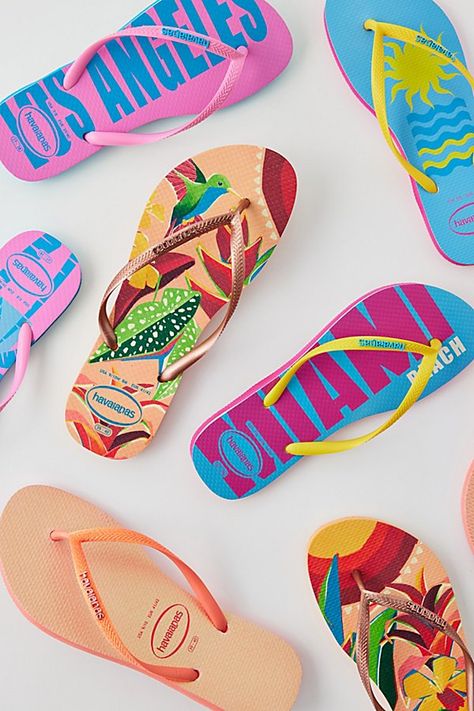 Printed Havaianas slim flip flops perfect for sunny days. Features Havaianas slim flip flops in beachy prints Sun-ready thong sandals Waterproof Slim strap silhouette Cushioned footbed Comfy textured sole Slip-on style Content + Care PVC, rubber Wipe clean Imported | Havaianas Printed Slim Flip Flop Sandal in Pink Print, Women's at Urban Outfitters Beachy Prints, Flatlay Ideas, Tropical Vacation Outfits, Personalized Flip Flops, Vacation Clothes, Havaianas Flip Flops, Orange Print, Flip Flop Slippers, Brand Sale