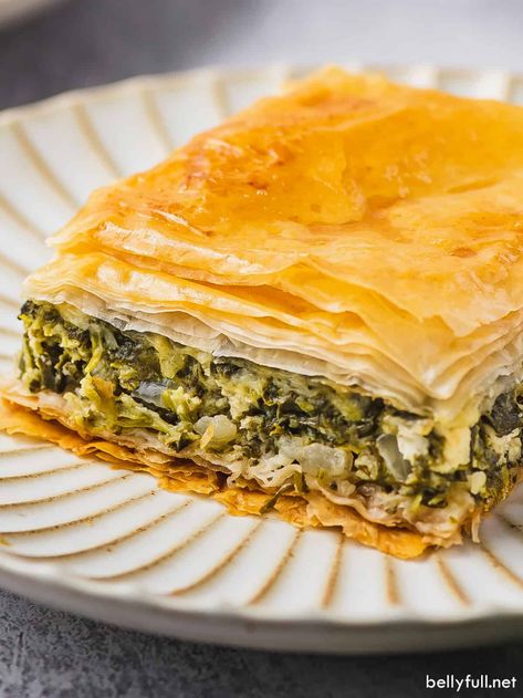 With a flaky phyllo dough crust and a creamy filling made of cheese, spinach, and herbs, this Spanakopita (Greek Spinach Pie) can be served as a main course, appetizer, or side dish. This classic savory Greek recipe is always a crowd-pleaser and easy to make too! Spinach Feta Pie, Spanakopita Recipe, Phyllo Dough Recipes, Greek Spinach, Greek Spinach Pie, Pasta Fillo, Spinach Pie, Phyllo Dough, Greek Dishes