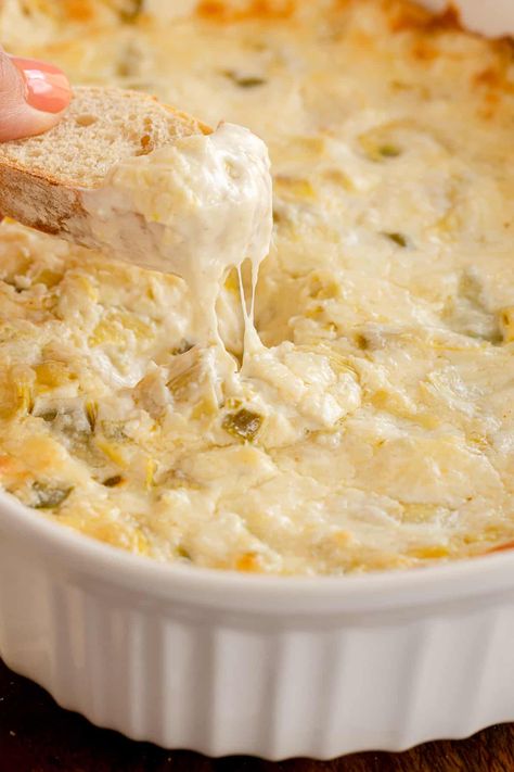 Warm and cheesy baked Artichoke Dip is a flavor-packed party classic! Chunks of artichoke hearts are baked into this creamy dip with tangy bits of jalapeno. Artichoke Dip Recipe Easy, Warm Artichoke Dip, Baked Artichoke Dip, Baked Artichoke, Artichoke Dip Recipe, Crab Dip, Artichoke Recipes, Creamy Dip, Dip Recipes Easy