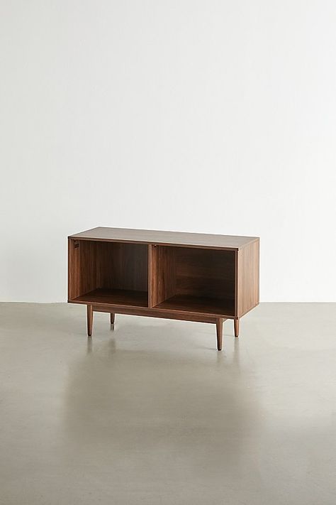 A simple yet stunning storage console, elevate your space with this multi-sectioned console with statement finishes and tapered legs for a mid-century feel. Perfect for storing your vinyl, record player, gaming consoles and more. Features Mid-century storage console from Crosley Multiple compartments offer versatile storage options Tapered legs Sized to fit full-size 12-inch records Holds up to 120 single LPs Versatile - use it to store your vinyl, gaming consoles, books and more Assembly requir Vinyl Console, Mid Century Storage, Retro Console, Storage Console, Record Table, Vinyl Record Player, Record Storage, Media Console, Record Player