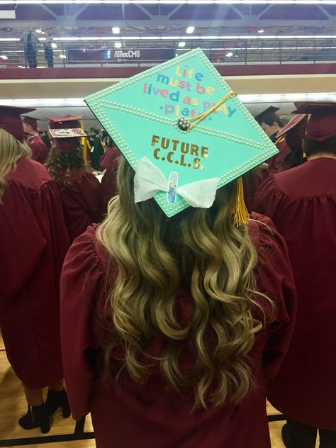 Tiffany's Themed Child Life Graduation Cap - "Life must be lived as play" - Plato  - Future CCLS -  bow made with gauze and a cinderella bandaid Child Development Graduation Cap, Grad Cap Ideas, Masters Graduation, College Graduation Cap Decoration, Child Life Specialist, Grad Cap Designs, Future Vision, Grad Caps, Cap Decoration