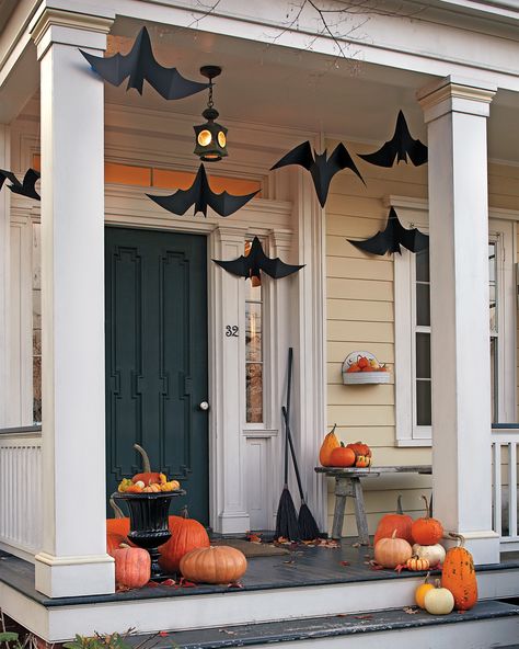 Made out of craft paper, these fluttering winged critters are a great way to welcome trick-or-treaters in hair-raising style by turning your front porch into a bat cave. #marthastewart #halloween #halloweendecor #diyideas #diyhalloween Porche Halloween, Diy Halloween Dekoration, Halloween Decor Diy, Casa Halloween, Halloween Front Porch Decor, Diy Halloween Decor, Halloween Flowers, Halloween Porch Decorations, Halloween Front Porch