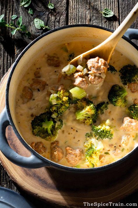 A Dutch oven filled with creamy broccoli sausage soup and a wooden spoon. Dutch Oven Soups, Sausage Soup Crockpot, Autumn Soup Recipes, Dutch Oven Soup, Broccoli Sausage, Sausage Broccoli, Autumn Soup, Cream Of Broccoli Soup, Broccoli Soup Recipes