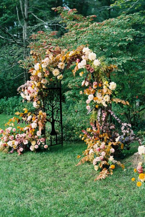 Wedding ceremony arbor of lush fall florals. Flowers in shades of blush, maroon, burgundy, orange and mustard Wedding Ceremony Arbor, Ceremony Arbor, Fall Ceremony, Shades Of Blush, Floral Arch Wedding, Wedding Arbour, Bride And Groom Portraits, Fall Florals, Shade Flowers