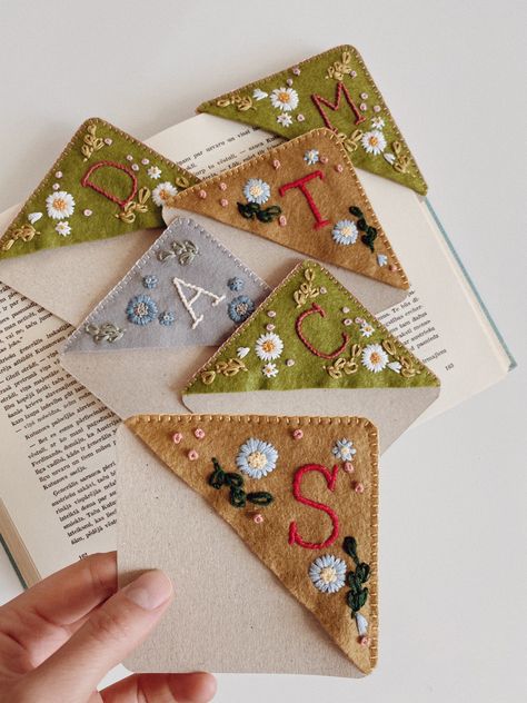 All stitched, wrapped and packed- personalized, hand embroidered corner bookmarks🔖 #moodygreenembroidery #handembroidery #floralembroidery #personalized #needlework #bookstagram #reading #booklovers #bookmark #etsy #etsyshop #etsyseller #etsyfinds #etsygifts #handcrafted Embroidery Corner Bookmark Diy, Felt Corner Bookmarks Diy, Corner Bookmark Diy, Corner Bookmarks Diy, Hand Embroidered Corner Bookmark Diy, Embroidered Book Mark Corner, Embroidered Corner Book Marks, Homemade Baby Shower Favors, Embroidered Corner Bookmark