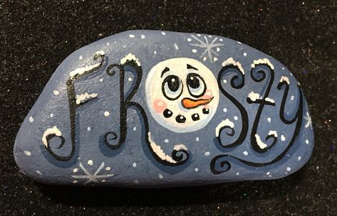 Hand painted rock Winter Painted Rocks, Christmas Rock Painting Ideas, Christmas Rock Painting Ideas Snowman, Rock Painting Winter Scenes, Winter Scene Painted Rocks, Painted Ice Skates, Christmas Stocking Painted Rocks, Christmas Stone Painting Pebble Art, Winter Themed Painted Rocks