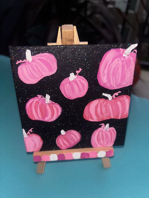 Sparkly background, pink pumpkin print. One of one, original hand painted acrylic on mini canvas, wooden easel included (comes painted as shown).  4x4 inch stretched canvas, with wooden easel, approximately 5 in tall. Cute, halloween gift or fall decor,  hand painted by me! could make a great addition to a spooky basket! 🎃 Halloween Themed Canvas Painting, Halloween Mini Painting, Halloween Mini Canvas Paintings, Pink Halloween Painting, Halloween Things To Paint, Pumpkin Painting Spooky, Pumpkin Painting Canvas, Pumpkin Painting On Canvas, Simple Fall Paintings