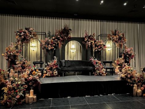 Layered floral tones and rich textures set the stage, while matching colored sand candles added the perfect finishing touch. Styling, decor, flowers and set up by @museweddingsandevents Candles by @rosewood.candles Decor Pernikahan, Khaleeji Wedding, Vintage Reception Decorations, Sangeet Decor, Wedding Stages, Indian Reception, Red Wedding Decorations, Wedding Stage Decor, Sand Candles