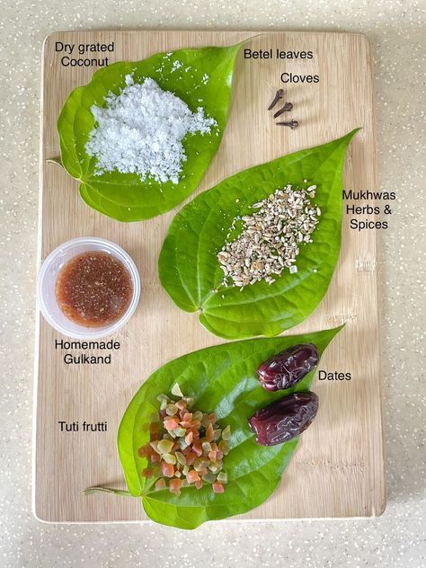 Ingredients - Betel leaf,Dry grated coconut,Cloves,Homemade Gulkand,Mukhwas Herbs & Spices,Tuti Frutti & Dates. Method - 1. Betel leaf -Wash,Pat dry,remove stalk 2. leaf facing down -place all the ingredients on the leaf 3. roll the edge of leaf & make pouch shape-keep all filled items inside 4. fold the leaf & insert clove to seal it. Done! Betel Leaf, Indian Cooking Recipes, Grated Coconut, Indian Cooking, Plastic Free, Dates, Coconut, Cooking Recipes, Herbs