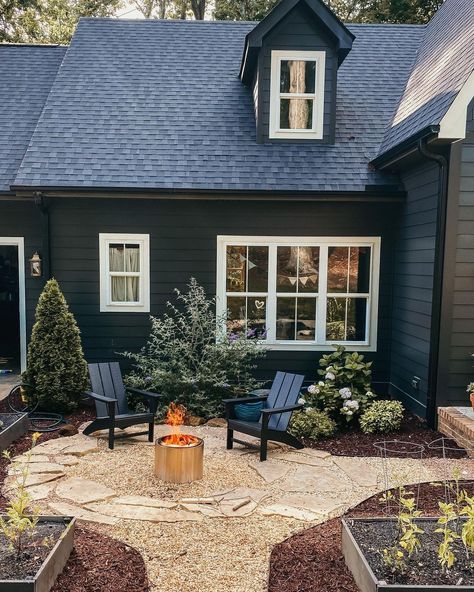 So many of you said as I’ve been talking about the fairy tale cottages (see my last reel) that our house felt like one of them! I designed… | Instagram Side Of House Oasis, Dark House Landscaping, Black Ranch House, Black Craftsman House, Dark Blue Exterior, Dark Home Exterior, Dark House Exterior, Dark Exterior House, Outside Paint Colors