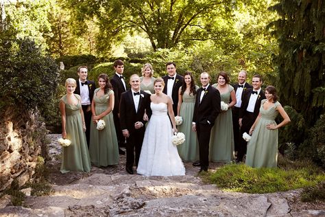 The bridal party was decked out in classic formal attire; the girls wore long sage green gowns with cap sleeves, while the guys wore sleek black tuxedos with black bow ties. Bridesmaid Dresses Pattern, Sage Bridesmaids, Dresses With Cap Sleeves, Patterned Bridesmaid Dresses, Botanical Garden Wedding, Sage Bridesmaid Dresses, Dresses Pattern, Green Tuxedo, Sage Wedding