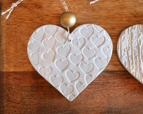 You will receive the 3 heart shaped tree ornaments in the photos. These are made of Plaster of Paris and are my own original design. Each one has a different design embossed on the front only. I made these by using rubber stamps and various elements from nature, like leaves and branches from my garden. So pretty and delicate. Each has a gold sparkly hanging cord and a metallic gold painted wood bead as well.These are also a gorgeous upgrade to your present-giving game! Add an ornament to the bow Heart Shaped Tree, Clay Gift Tags, Clay Christmas Decorations, Metallic Gold Paint, Diy Plaster, Heart Christmas Ornaments, Polymer Clay Gifts, Leaves And Branches, Plaster Of Paris