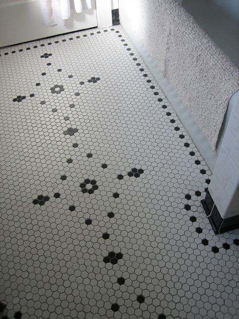 This white hex tile floor with a pretty black pattern has a vintage, feminine vibe Hexagon Bathroom Tile, Classic Bathroom Tile, Hex Tile Floor, Hexagonal Tiles, Honeycomb Tile, Vintage Bathroom Tile, Hexagon Tile Floor, Hex Tile, Penny Tile