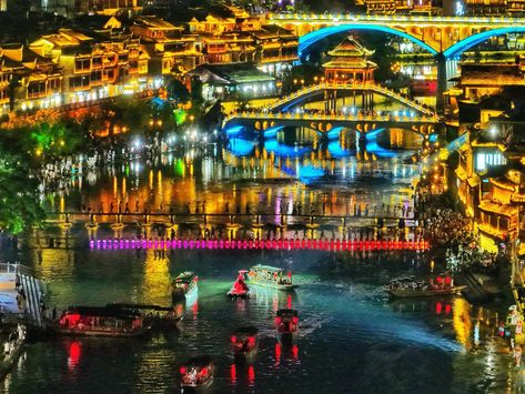 Looking for a magical summer getaway? Look no further than #Fenghuang Ancient Town in #Hunan province! It has become a hotspot for tourists in the summer. The Tuojiang River banks come to life with a dazzling display of lights. River Bank, Summer Getaway, Jump In, Travel And Tourism, Summer Vacation, Banks, Tourism, Travel