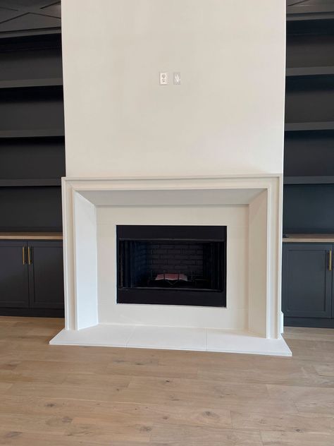 Fluted Cast Stone Fireplace, Precast Fireplace Surround, Modern White Mantle, Modern Cast Stone Fireplace Surround, Minimal Fireplace Mantel, Noncombustible Fireplace Mantel, Modern Built Ins Around Fireplace, Cast Stone Fireplace With Raised Hearth, Plaster Fireplace With Hearth