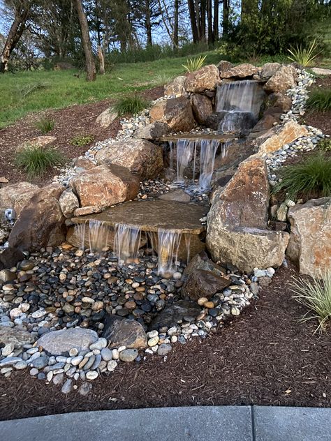 Hillside Waterfall And Pond, Unique Pond Waterfall Ideas, Waterfall Stream Backyard, Large Pond Waterfall Ideas, Rock Waterfalls Backyard, Waterfall Diy Backyard, Backyard Pond Waterfall, Garden Waterfalls Ideas Landscaping, Backyard River Ideas