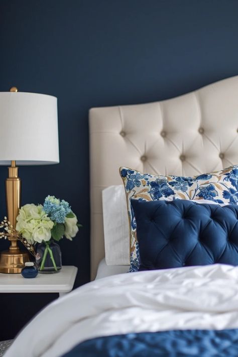 A beautifully decorated bedroom showcasing navy blue walls, layered with gold accents in beddings and decor, illustrating elegant design inspiration. Blue Gold Room Aesthetic, Blue And Gold Master Bedrooms Decor, Navy White And Gold Bedroom, Navy Blue And Gold Bedroom, Navy And Gold Bedroom, Blue And Gold Bedroom Ideas, Gold Decor Ideas, Blue And Gold Decor, Gold Bedroom Ideas