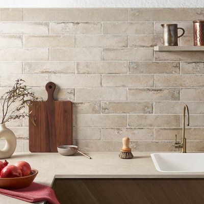 A striking collection of stone-look porcelain, Granda evokes a feeling of luxury and lavish refinement at a fraction of the cost of actual stone tile. Inspired by Spain’s Andalusia region, a city that is synonymous with flamenco dancing and ornate castles, Seville captures the true natural beauty of marble in a unique and durable porcelain tile that would be the perfect addition to your home or commercial space for generations to come. Bond Tile Colour: Pergamo | Bond Tile Granada 3" x 12" Porce French Country Kitchen Tile Backsplash, Natural Tile Backsplash Kitchen, Porcelain Tile Kitchen Backsplash, Natural Stone Backsplash Kitchen, Diy Stone Backsplash, Stone Tile Backsplash Kitchen, Stone Kitchen Backsplash, Backsplash Kitchen White Cabinets, Artmore Tile