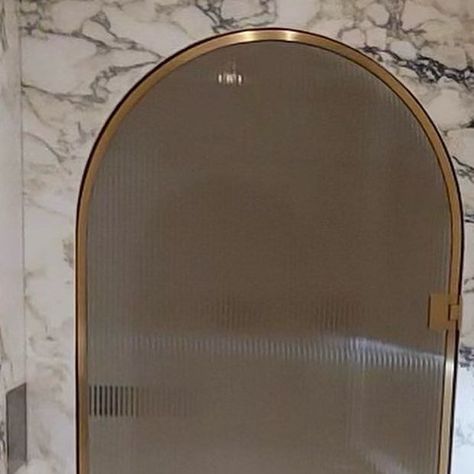 Vast Interiors Limited on Instagram: "What could be better than stepping in to your own personal spa every day? #thevastdifference Starphire reeded glass shower door, wrapped in bent burnished brass frame & conformed to match the shape of the arched marble opening. Builder: @wpmlinc #vastinteriorslimited" Reed Glass Shower Door, Arched Shower Door, Swinging Shower Door, Glass Shower Door, Shower Glass, Reeded Glass, Brass Shower, Burnished Brass, Glass Shower Doors