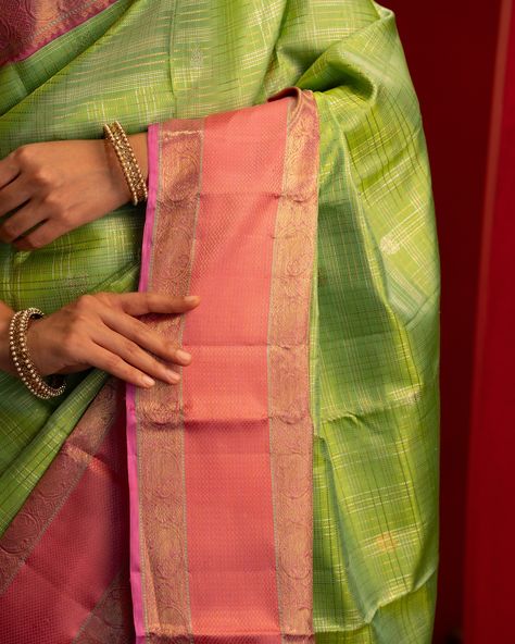 Featuring the captivating light green kanjivaram silk saree woven with muthu kattam in gold and silver zari along with anaapakshi buttis on the body. The korvai rettai pettu rose pink border on both sides with rich zari pallu. Saree code: CL110376 Light Green Silk Saree, Gold And Silver, Light Green, Silk Sarees, Pink Roses, Saree, Wonder, Green, Pink