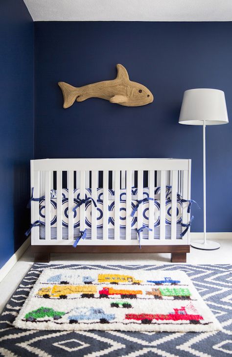 Gorgeous nursery with navy blue walls framing shark wall decor over a modern white crib Transitional Nursery, Modern Baby Furniture, Modern Baby Room, Rug Over Carpet, Baby Nursery Design, Boys Room Rugs, Vintage Style Rugs, Navy Walls, Brown Carpet