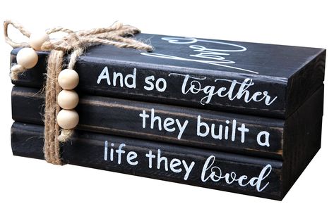 PRICES MAY VARY. 【HANDCRAFTED WOOD BOOK STACK】This farmhouse stacked books decor consists of 3 books made of solid cedarwood. Black painted with slight distressing finish. Cute "Love" printed on top book face, while books' spine has warm inspirational quote "And so together they built a life they loved". 3 farmhouse wood books glued together, won't move to get loose, bookstack bound with rustic twine,the hemp rope's ends are threaded with wood beads. 【IDEAL FOR HOME DECOR】This farmhouse inspired Stacked Books Decor, Table Books Decor, Books Coffee Table, Coffee Table Books Decor, Book Centerpieces, Stacked Books, Books Decor, Black Farmhouse, Books Coffee