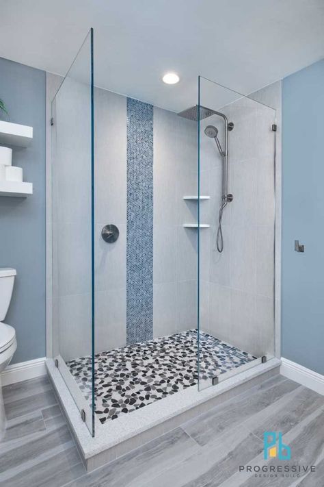 The large open shower features: -An Emser Cultura pebble tile floor -An American Olean Herringbone vertical tile accent wall -Kohler shower fixtures including a luxurious 10” rainhead that offers soft and gentle soothing warmth, without heat loss or splash Shower With Vertical Accent Tile, Outdoor Kitchen Remodel, Pebble Tile Floor, Vertical Tile, Shower Accent Tile, Pool Outdoor Kitchen, Kohler Shower, Tile Accent Wall, Open Showers