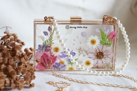 New drops: Beautiful floral resin clutch 👜 Elevate your style quotient in a blink with these exquisite floral resin clutches. Available in all these designs, check them out now! DM to order or enquire for prices! 💌 #resinclutch #resinclutches #resinclutchbag #resinpurse #resinbag Resin Clutch, Resin Bag, Floral Resin, Elevate Your Style, Bag Making, Clutches, Your Style, Clutch Bag, Floral