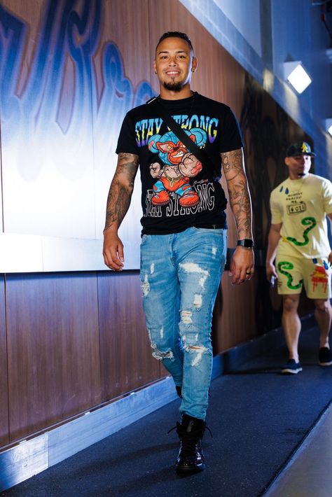 Orlando Arcia arrives at the clubhouse with a "Stay Strong" graphic tee featuring a cartoon mouse and distressed jeans. Atlanta Braves, Orlando, Atlanta, Mens Outfits, Mens Graphic Tshirt, Mens Tshirts, Mens Tops