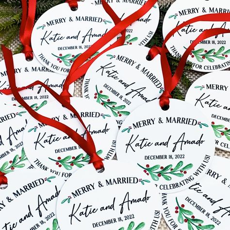 "Customize these watercolor winter floral greenery Christmas ornaments as a unique holiday wedding favor for your guests! Choose either ceramic or natural wood ornaments, and personalize with your names and wedding date.  Design comes with the \"Merry & Married\" and \"Thank you for celebrating with us\" text.  𝗚𝝞𝗙𝗧 𝝗𝗔𝗚 𝗢𝗥 𝝗𝝤𝝬 𝝞𝗦 𝝞𝝢𝗖𝗟𝗨𝗗𝗘𝗗 Each wood ornament comes with a velvet pouch. Each ceramic ornament comes with a gift box.   𝗢𝗥𝗡𝗔𝗠𝗘𝗡𝗧 𝗗𝗘𝗧𝗔𝗜𝗟𝗦 * Size: 3\" round  * One sided print * Coordinating ribbon is included for hanging  𝗪𝝤𝝤𝗗 𝗢𝗥𝗡𝗔𝗠𝗘𝗡𝗧𝗦 * Natural wood ornaments * Comes with drawstring non-scratch velveteen pouch 𝗖𝗘𝗥𝗔𝗠𝝞𝗖 𝗢𝗥𝗡𝗔𝗠𝗘𝗡𝗧𝗦 * Smooth gloss finish * Durable ceramic * Comes with gift box 𝙋𝙇𝙀𝘼𝙎𝙀 𝙉𝙊𝙏𝙀: Due Christmas Ornament Favors Wedding, Ornaments For Wedding Favors, Wedding Ornament Favors, Wedding Favor Ornaments, Christmas Ornament Wedding Favors, Christmas Ornament Favors, Wedding December, Ornament Wedding Favors, Greenery Christmas