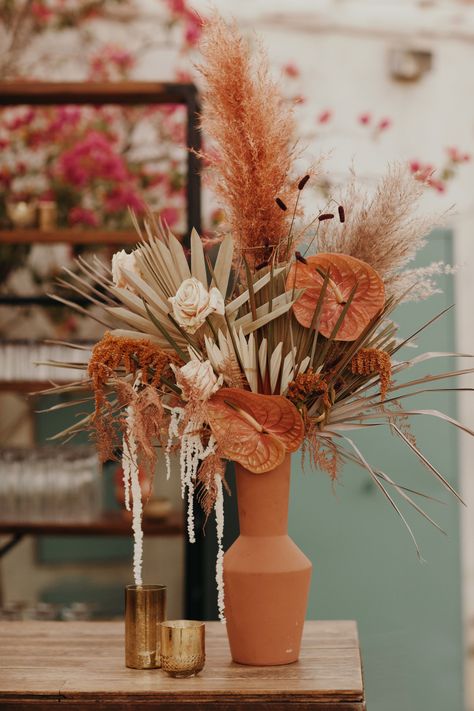 The dreamiest wedding at the famous Korakia Pension in Palm Springs. A more refined take on desert boho with softer and more romantic color palette. Peaches, mustards, golds, burnt orange, ivory, terra cotta, taupes, tan, dusty blush. Carnations, garden roses, fan palms, anthurium, orchids, dahlias, amaranths, dyed plumosa, painted palms, pampas grass, chocolate cosmos, combo roses. Venue: Korakia Pensione. Photographer: Jordan Voth. Coordination: Lovely Time Events. Florals: Foxtail Florals. Tropical Desert Wedding, Desert Flower Arrangements, Engagement Drinks, Carnations Garden, Blush Carnations, Korakia Pensione, Terra Cotta Wedding, Romantic Colors Palette, Chocolate Cosmos