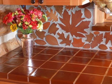 Mexican ceramic tiles hand painted in terra cotta are one of the most popular colors. Terra cotta tiles come in two variations. Either they are solid color or finished with washed technique. It inv… Farm Outdoor Kitchen, Terracotta Tile Floor Kitchen, Oak And White Kitchen, Counter Top Materials, Terracotta Tiles Kitchen, Tile Counter Tops, Leaf Tiles, Mountain Room, Terracotta Tile Floor