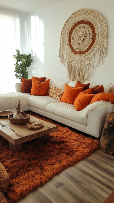 Bohemian living room featuring a white sofa, orange pillows, fur rug, macrame wall hanging, and rustic decor in earthy tones. Rust Couch Living Room, Orange Couch Aesthetic, Rust Couch Living Room Ideas, Rustic Coffee Table Decor, Boho Mid Century Modern Living Room, Inviting Home Decor, Warm Inviting Home, Boho Mid Century Modern, Unique Macrame