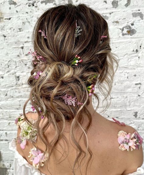 Wavy Bun with Flowers Fairy Princess Wedding Hair, Floral Updo Hairstyles, Enchanted Garden Hairstyle, Fairytale Updo, Messy Bun With Flowers, Boho Wedding Hair Updo, Fairy Wedding Hair, Wedding Hairstyles Boho, Bohemian Updo Hairstyles