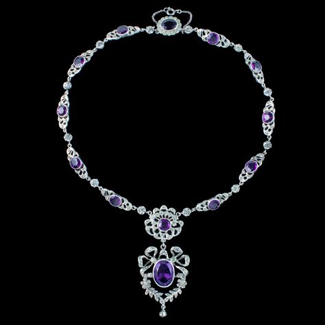 New in! A magnificent antique Edwardian paste lavaliere necklace consisting of ornate silver links leading to a spectacular open-work dropper pendant featuring pretty bow and floral motifs. Each link is bezel set with a large purple paste and accompanied by smaller clear pastes that together simulate amethysts and diamonds. The antique necklace dates to the early 1900s and has remained in excellent condition. It’s held by a safety chain and a flower-shaped box clasp at the end topped with f... Edwardian Necklace, Flint Glass, Edwardian Engagement Ring, Ancient Jewellery, Edwardian Jewelry, Box Clasp, Safety Chain, Antique Necklace, Ancient Times