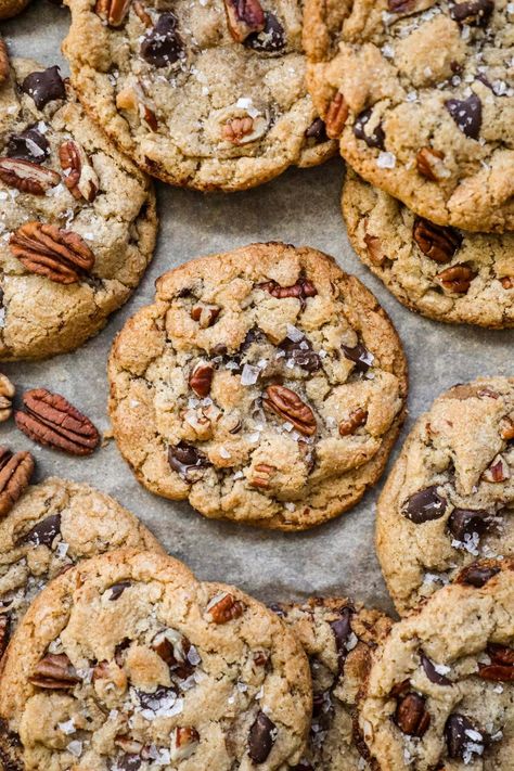 Brown Butter Pecan Chocolate Chip Cookies have a crispy-chewy texture, the irresistible crunch of pecans, and the rich sweetness of chocolate chips. Made with toasty brown butter for a touch of warmth, these cookies are topped with a sprinkle of flaky sea salt, elevating their flavor to new heights. Brown Butter Pecan White Chocolate Chunk Cookie, Southern Living Chocolate Chip Cookies, Brown Butter Pecan White Chocolate Chunk, Brown Butter Holiday Cookies, Chocolate Chunk Pecan Cookies, Oatmeal Toffee Pecan Cookies, Brown Butter Chocolate Chip Cookies With Sea Salt, Chocolate Praline Cookies, Salted Caramel Chocolate Chip Pecan Cookies