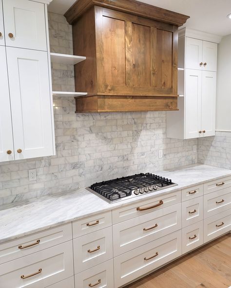 Transform your kitchen into a masterpiece with the perfect blend of rustic wood and sleek marble! 🌿✨ The custom wooden range hood adds a cozy, natural touch, while the marble backsplash offers a sophisticated, timeless look. Paired with modern appliances and stylish hardware, this kitchen is where function meets elegance. 🍽️🏡 Flooring supplied and installed by: @owsiflooringanddesign Built by: @gemstonedevelopment #OwsiUsa #KitchenTransformation #RusticMeetsModern #MarbleBacksplash #CustomW... Wood Hoods Kitchen, Wooden Range, Wooden Range Hood, Hood Ideas, Kitchen Transformation, Marble Backsplash, Modern Appliances, The Marble, Range Hoods