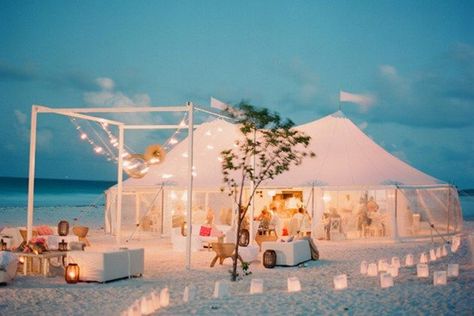 This white tent, surrounded by candles in white paper bags, blends perfectly into its beach setting. We love the flags up top—and the clear sides, which prevent guests from being splashed by crashing waves nearby. Bahamas Wedding, Beach Wedding Reception, Wedding Beach Ceremony, Outdoor Wedding Reception, Beach Wedding Decorations, Beach Theme Wedding, Beach Chic, Wedding Checklist, Glam Wedding