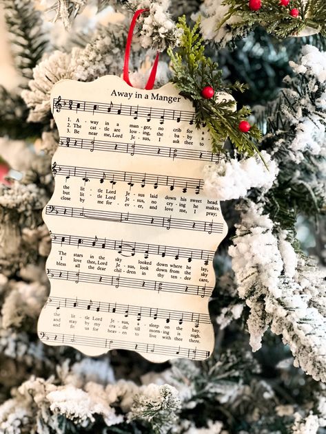 how to mod podge christmas hymns to create ornaments Vintage Christmas Decorations Diy Sheet Music, Hymn Ornaments Diy, Christmas Ornaments Made From Sheet Music, Diy Wooden Christmas Ornaments Ideas, Hymnal Ornaments Diy, Christmas Carol Ornament Diy, Modge Podge Wood Ornaments, Mod Podge Ornaments Diy, Modge Podge Christmas Ornaments