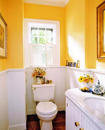 Bright and Cheery Bath: Echoing the wall color with the bouquets of fresh flowers makes this room a delightful addition to any home. Tiles Design For Hall, Bathroom Beadboard, Country Cottage Bathroom, Country Bathroom Designs, Beadboard Paneling, Yellow Bathroom Decor, Makeover Kamar Mandi, Cottage Bathroom Ideas, Wainscoting Bathroom